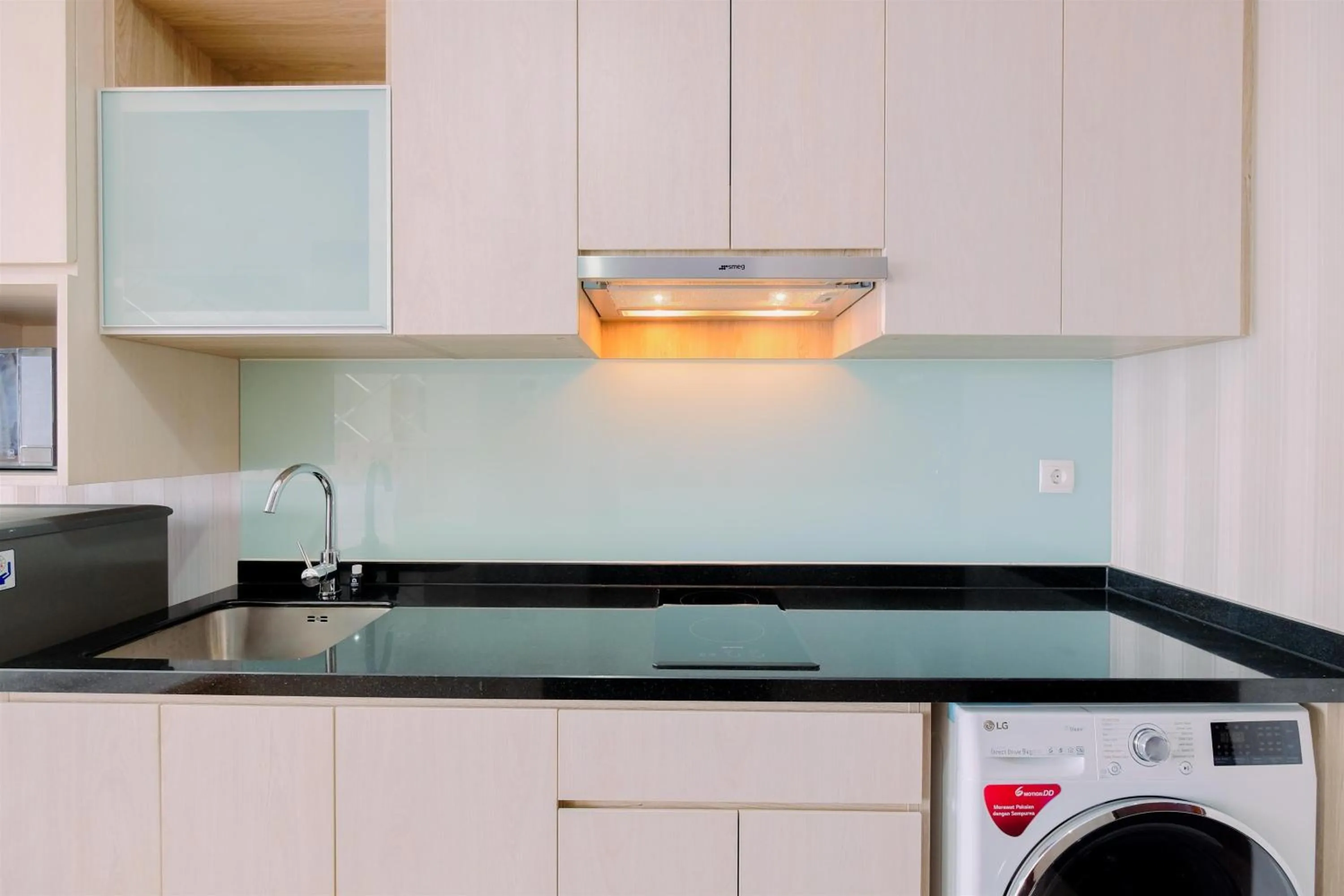 Kitchen or kitchenette in Comfort and Modern Look Studio Menteng Park Apartment By Travelio