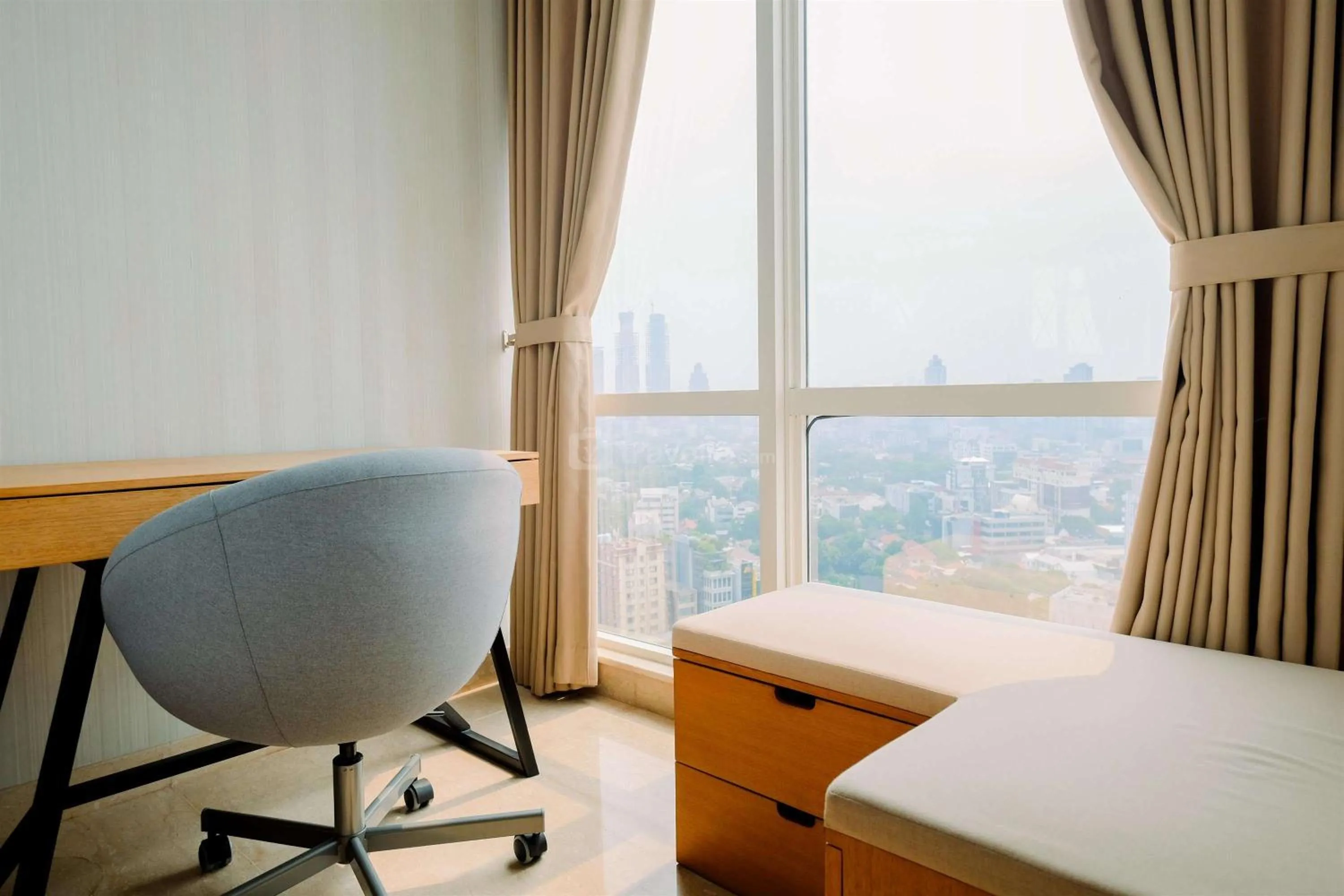 Seating area, Bed in Comfort and Modern Look Studio Menteng Park Apartment By Travelio