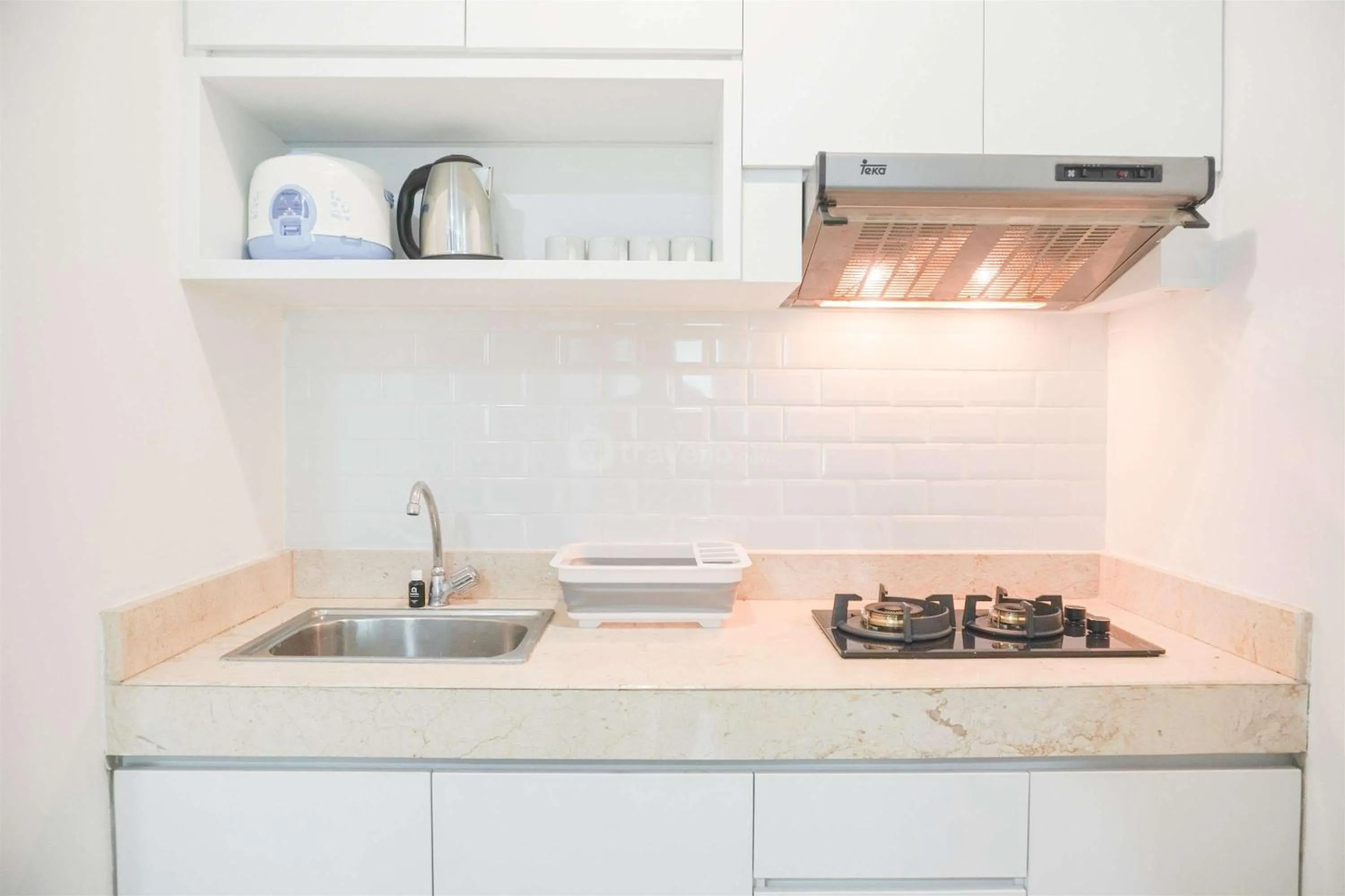Kitchen or kitchenette in Modern and Homey 2BR at MT Haryono Square Apartment By Travelio