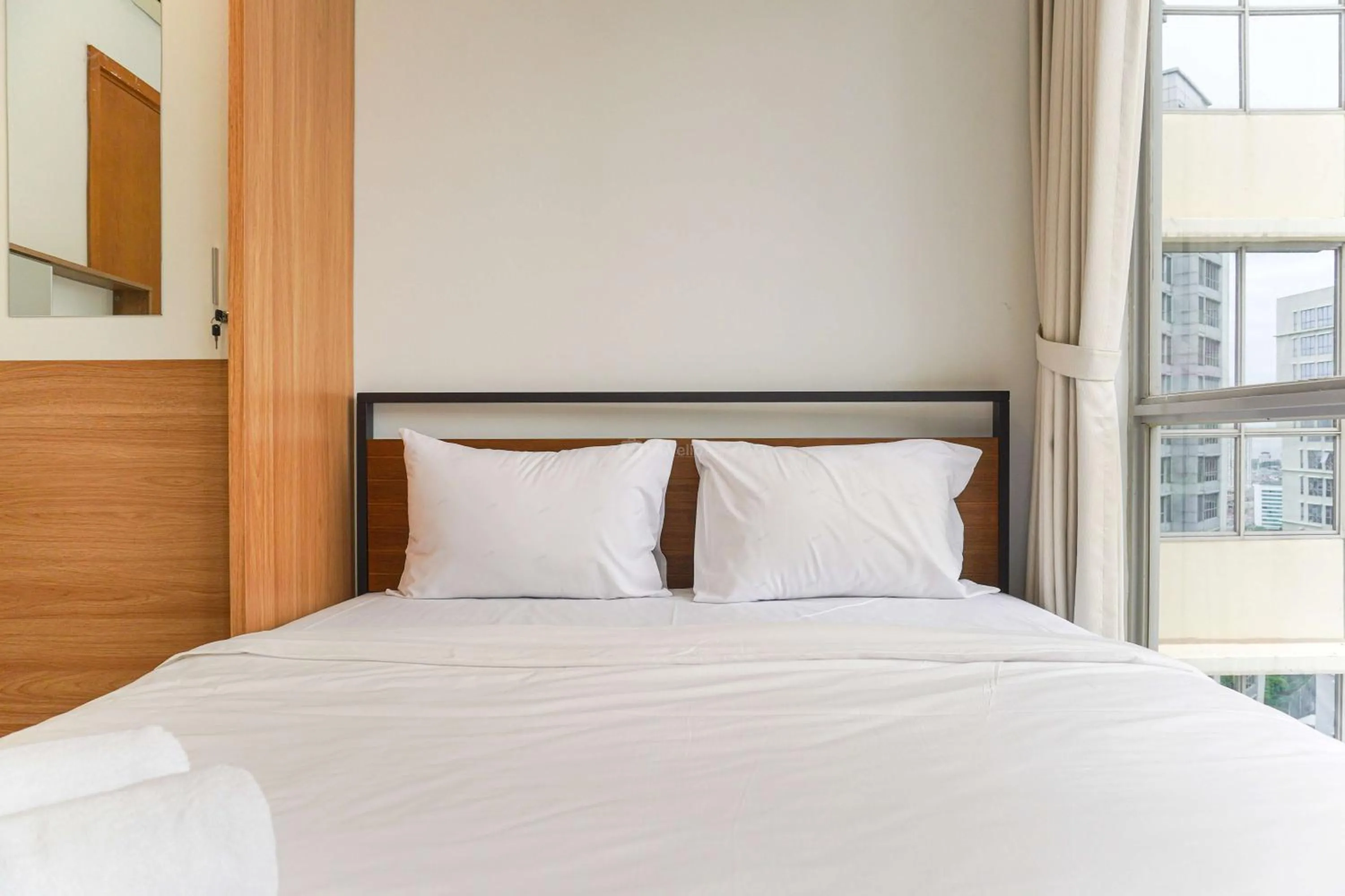 Bed in Minimalist Design 2BR Apartment The Mansion Kemayoran near JIEXPO By Travelio