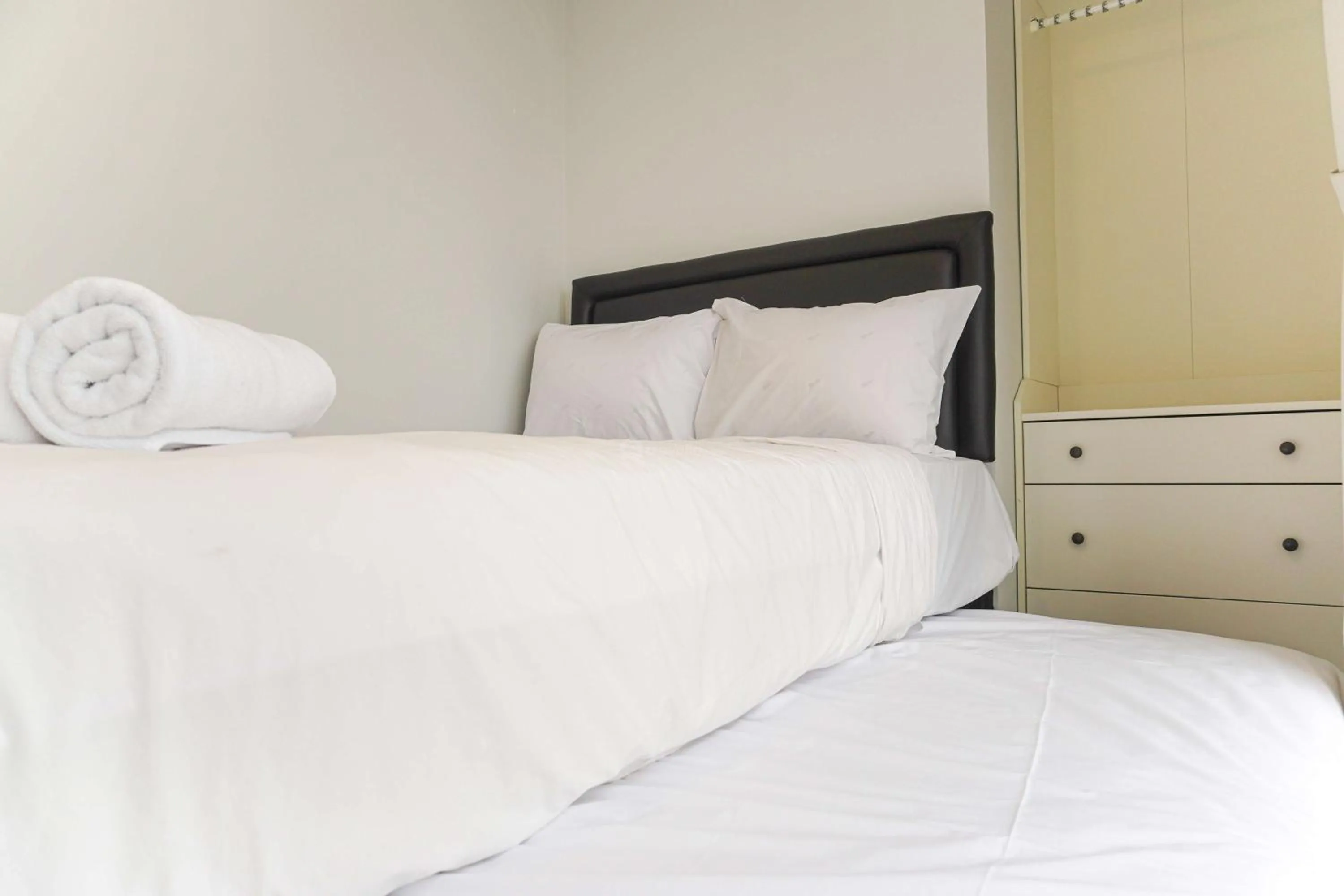Bed in Minimalist Design 2BR Apartment The Mansion Kemayoran near JIEXPO By Travelio