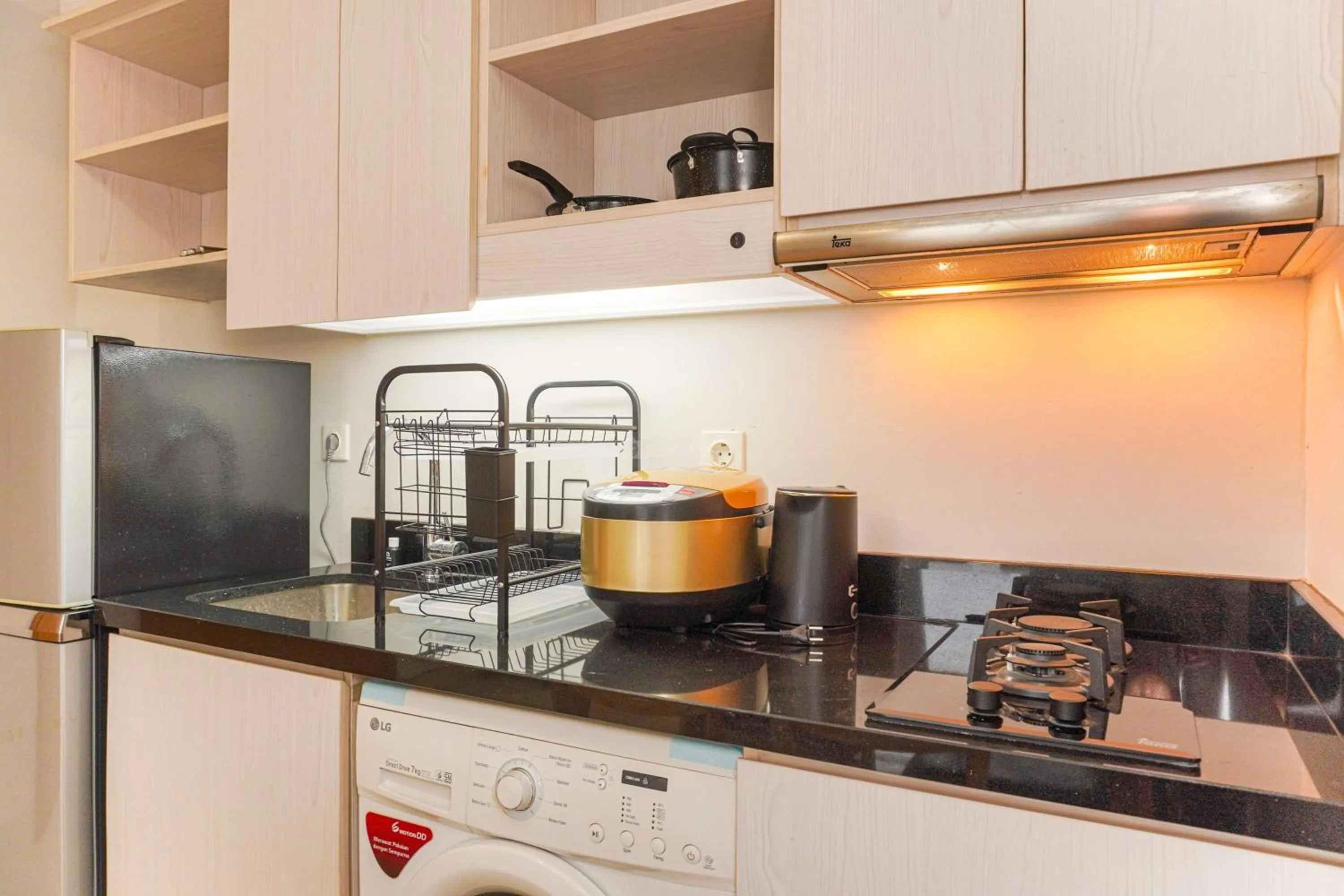 Kitchen or kitchenette in Minimalist Design 2BR Apartment The Mansion Kemayoran near JIEXPO By Travelio
