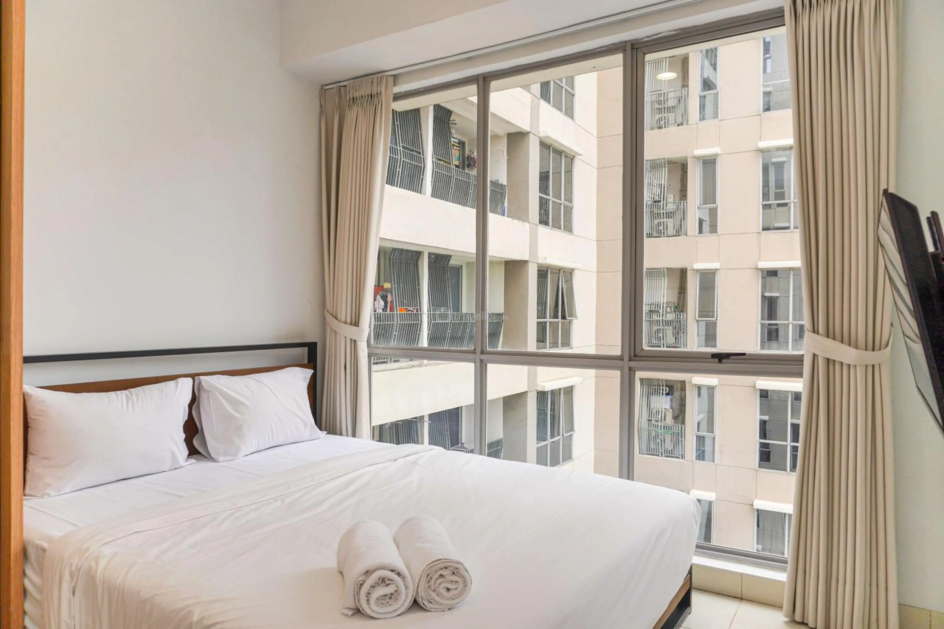 Bed in Minimalist Design 2BR Apartment The Mansion Kemayoran near JIEXPO By Travelio