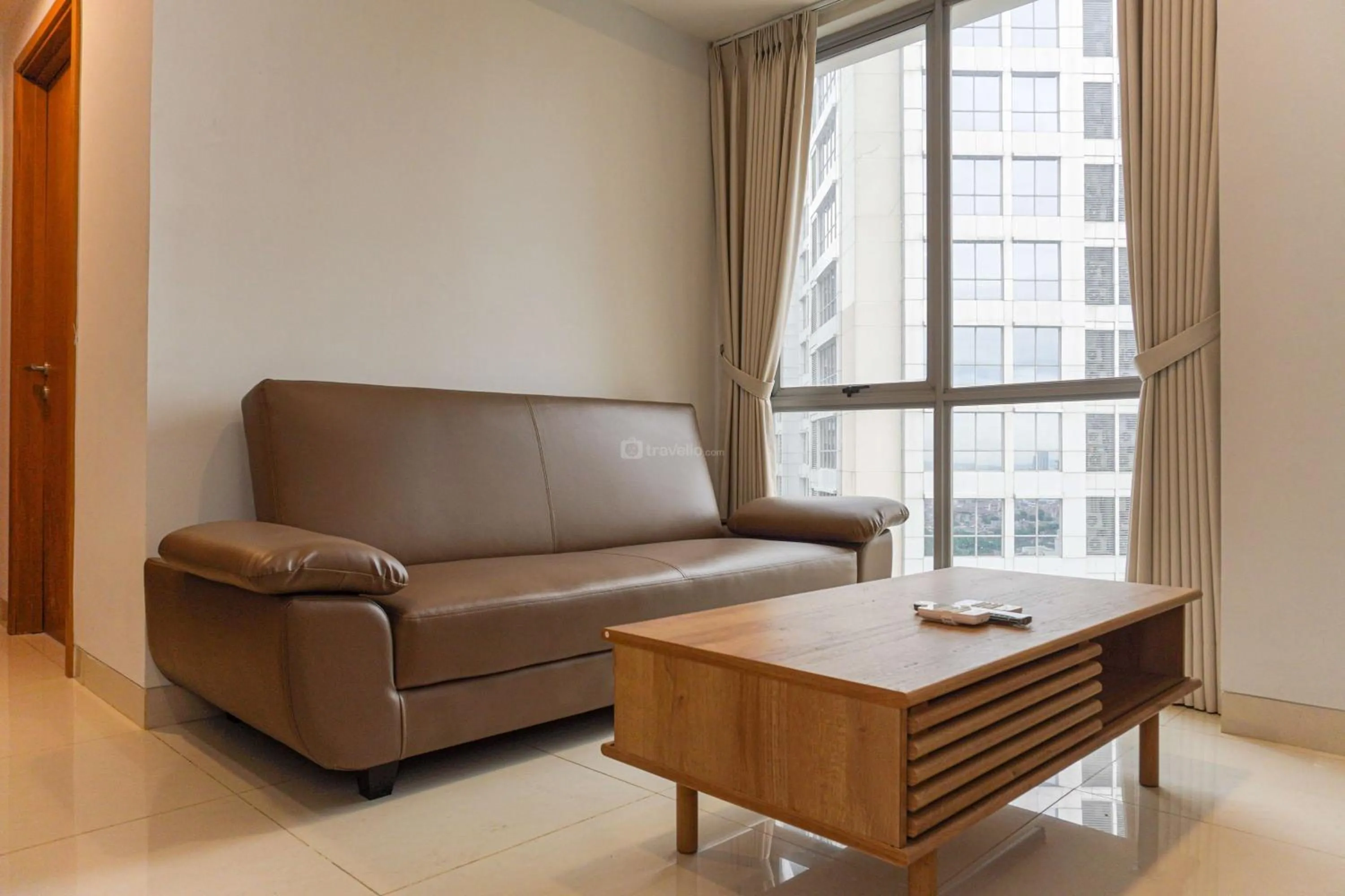 Living room in Minimalist Design 2BR Apartment The Mansion Kemayoran near JIEXPO By Travelio