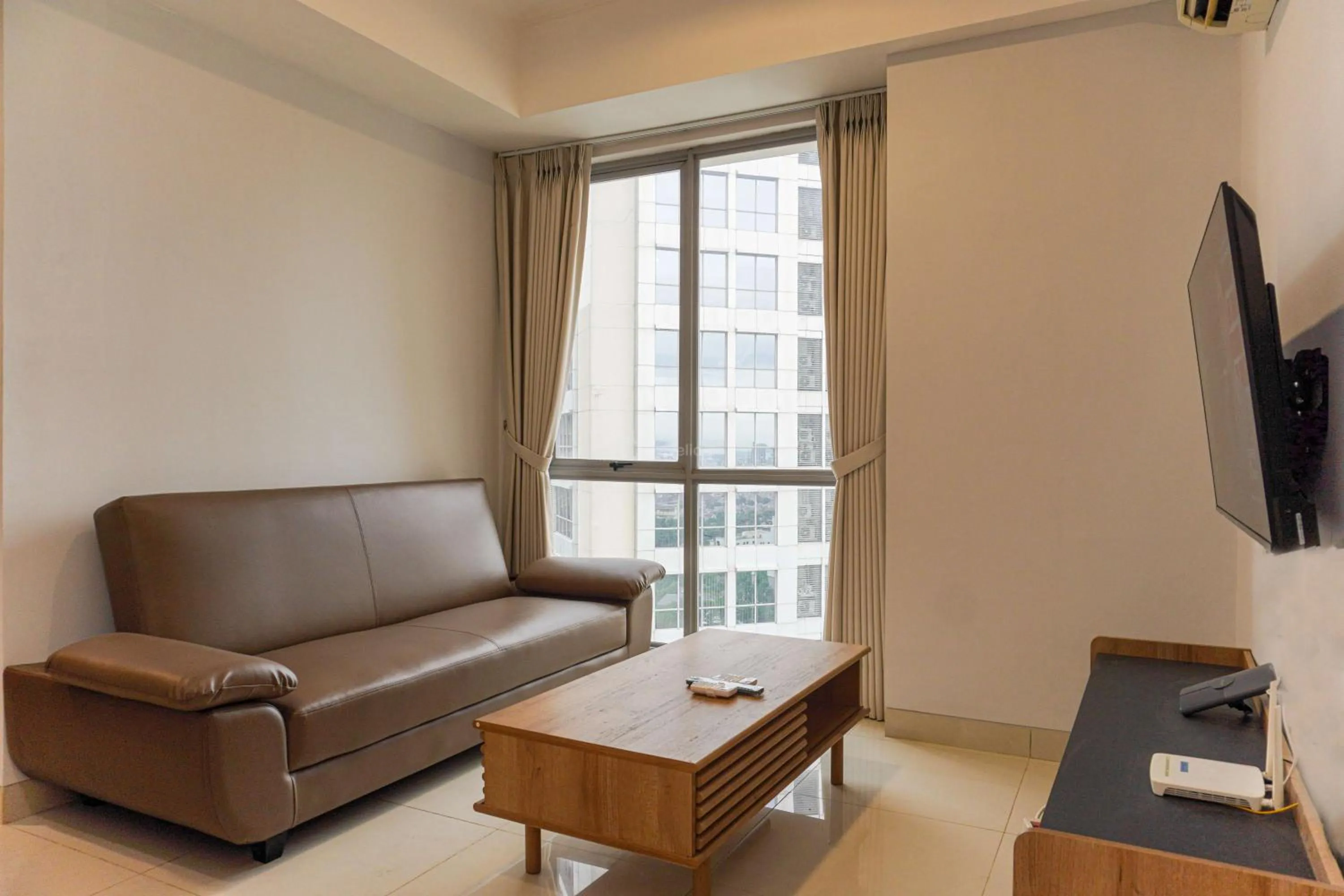 Bed in Minimalist Design 2BR Apartment The Mansion Kemayoran near JIEXPO By Travelio