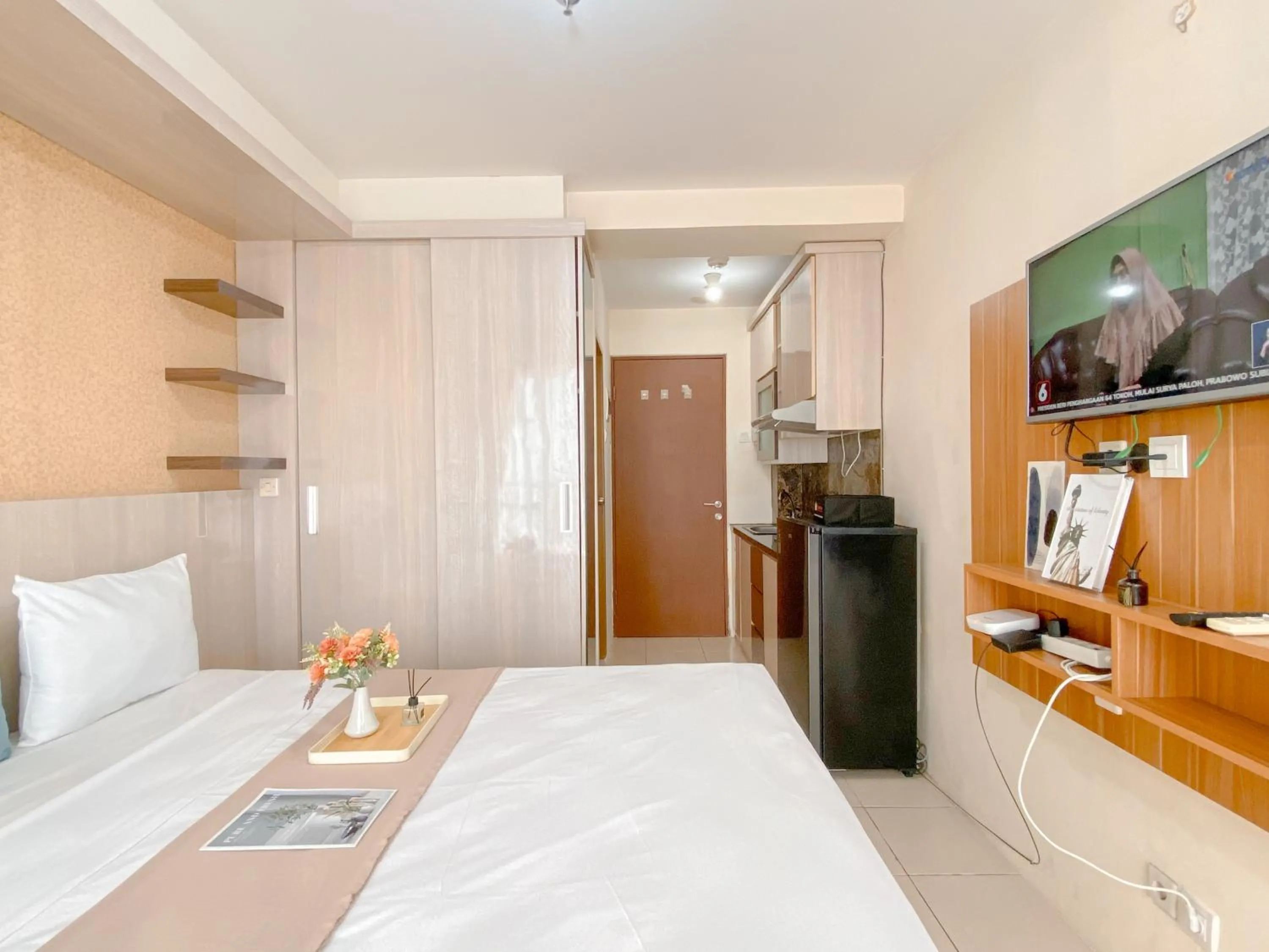 Bed in Modern Look and Comfy Studio Tifolia Apartment By Travelio