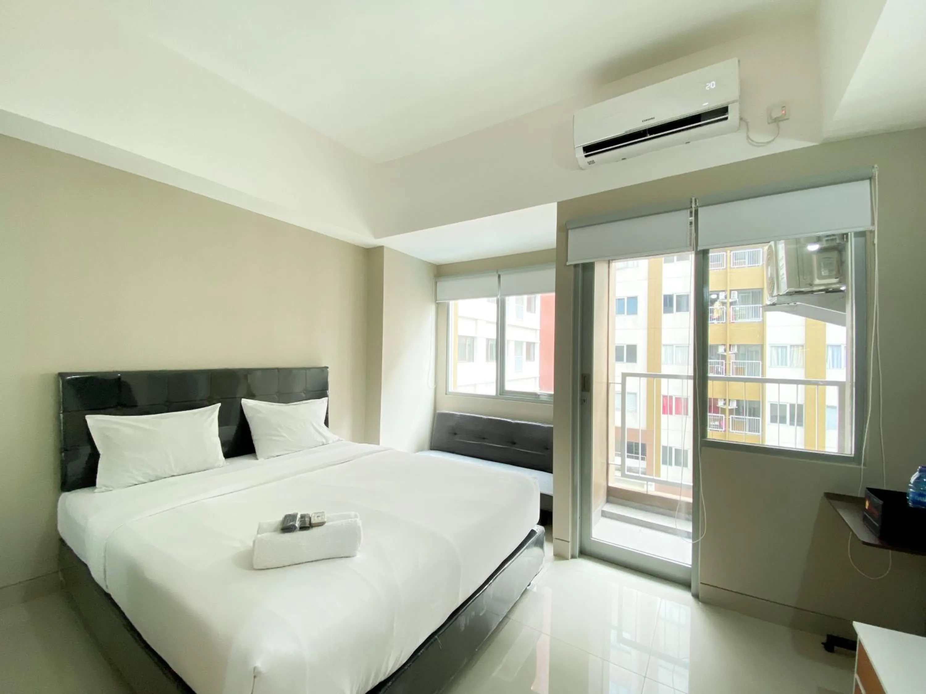 Bed in Homey and Cozy Stay Studio Gateway Park LRT City Jatibening Apartment By Travelio