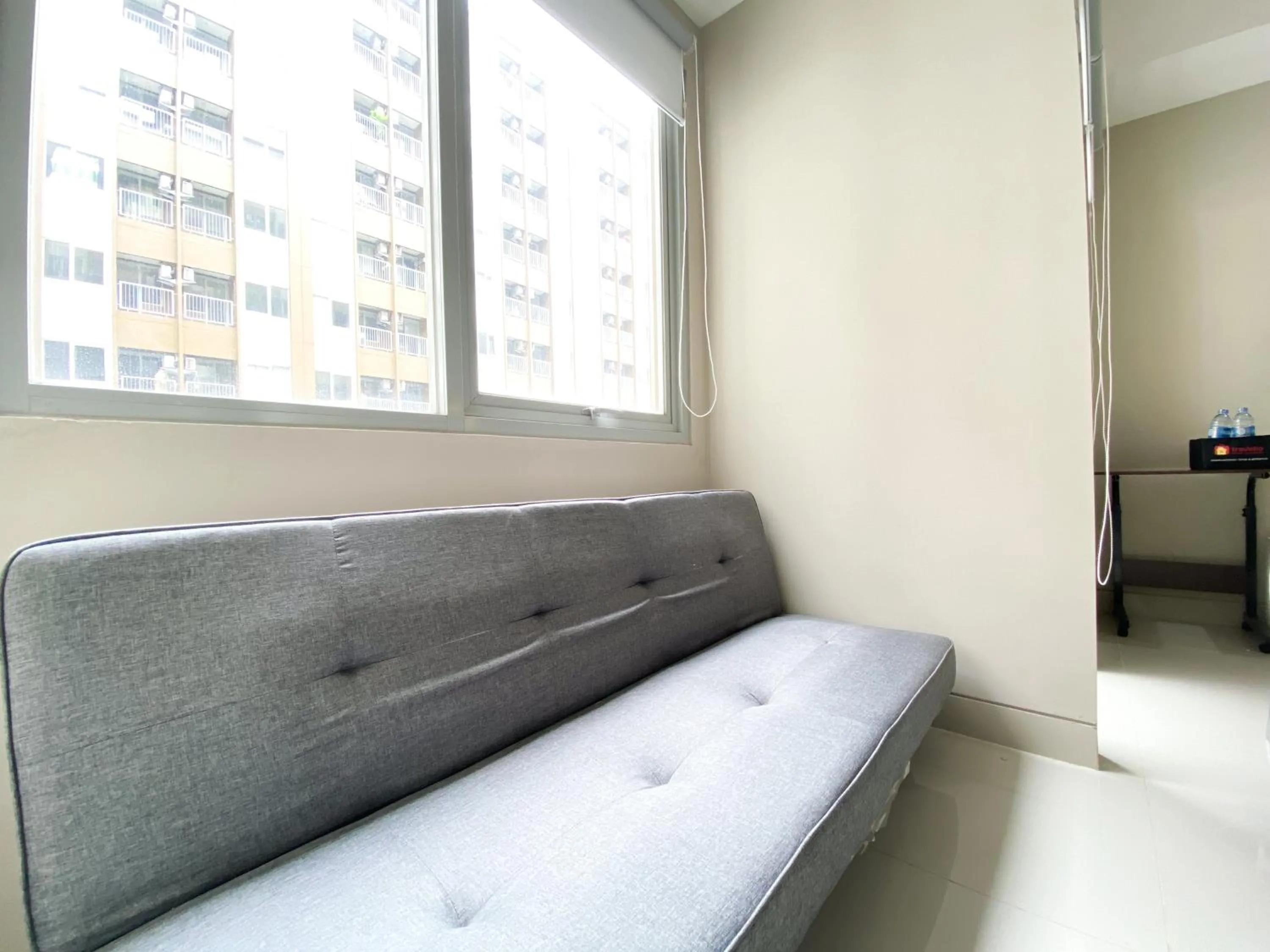Seating area, Bed in Homey and Cozy Stay Studio Gateway Park LRT City Jatibening Apartment By Travelio