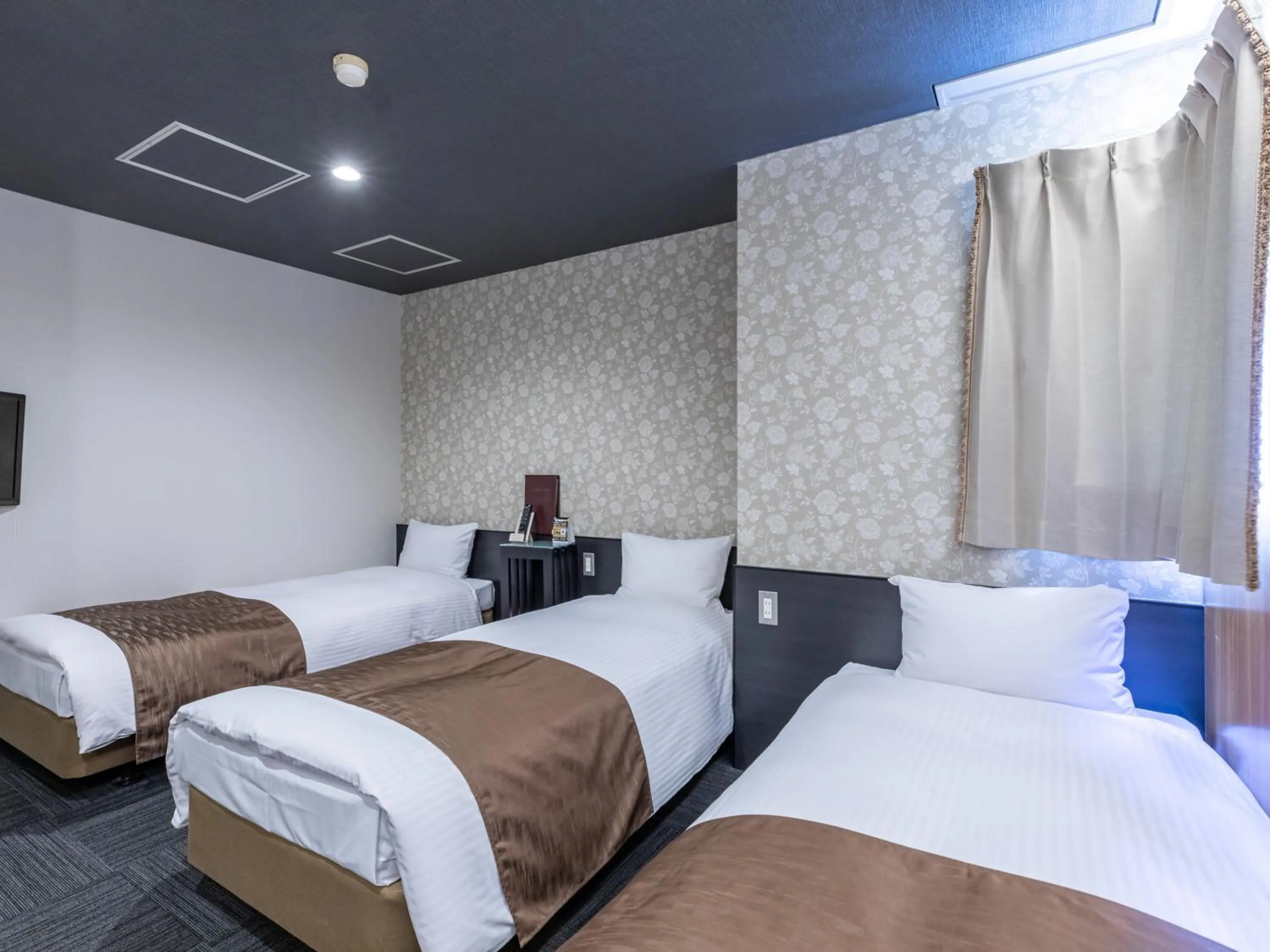 Bed in Tabist Takamatsu Pearl Hotel