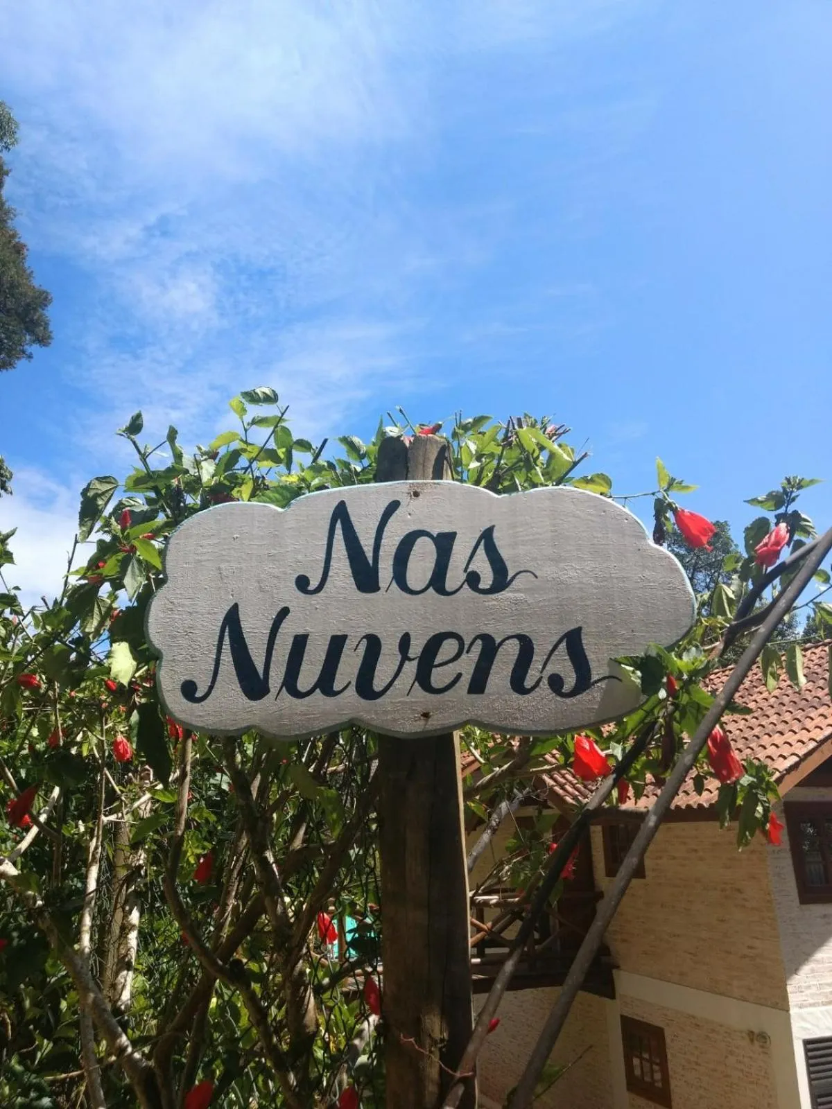 Property logo or sign in Nas Nuvens Hospedaria