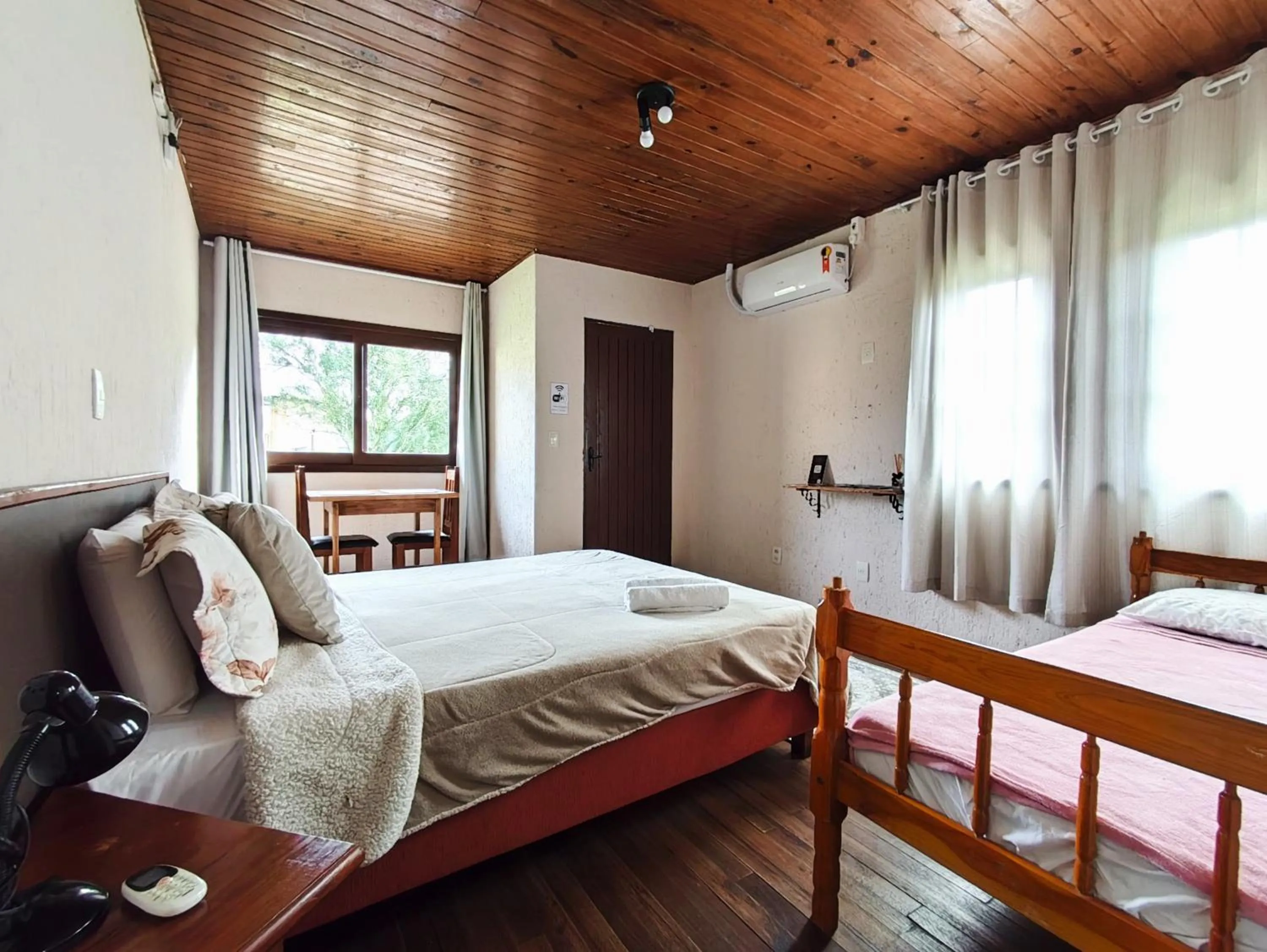 Bed in Chalés Pousada Malacara