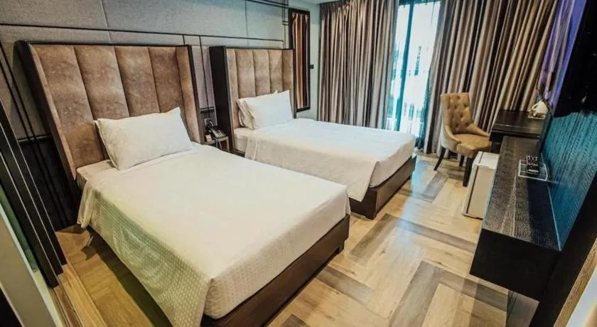 Bed in First Pride Hotel Bangkok