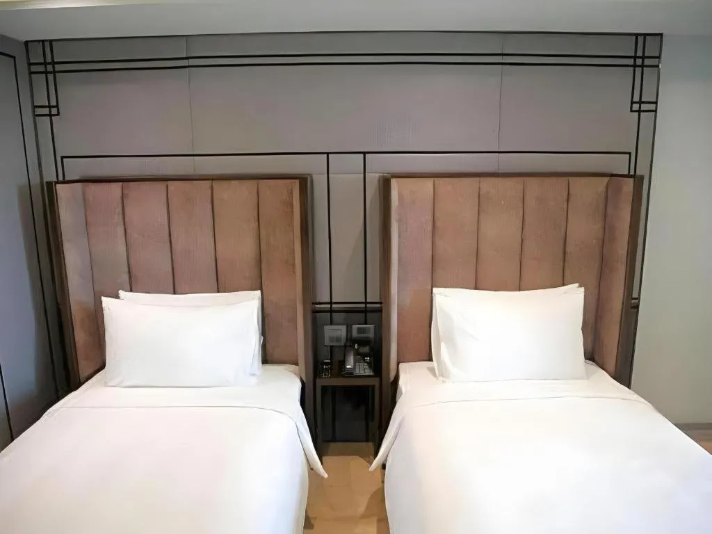 Bed in First Pride Hotel Bangkok