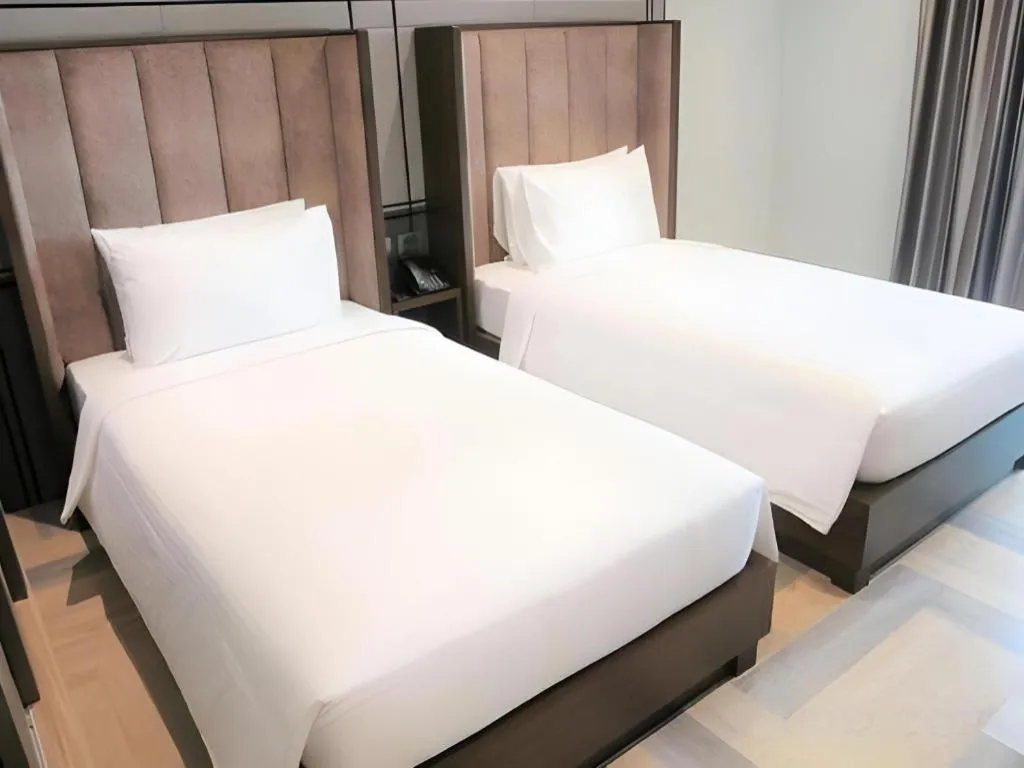 Bed in First Pride Hotel Bangkok
