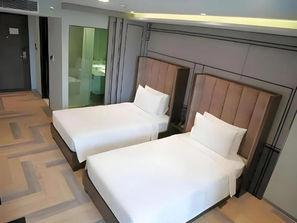 Bed in First Pride Hotel Bangkok