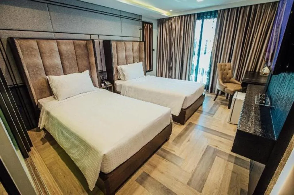 Bed in First Pride Hotel Bangkok