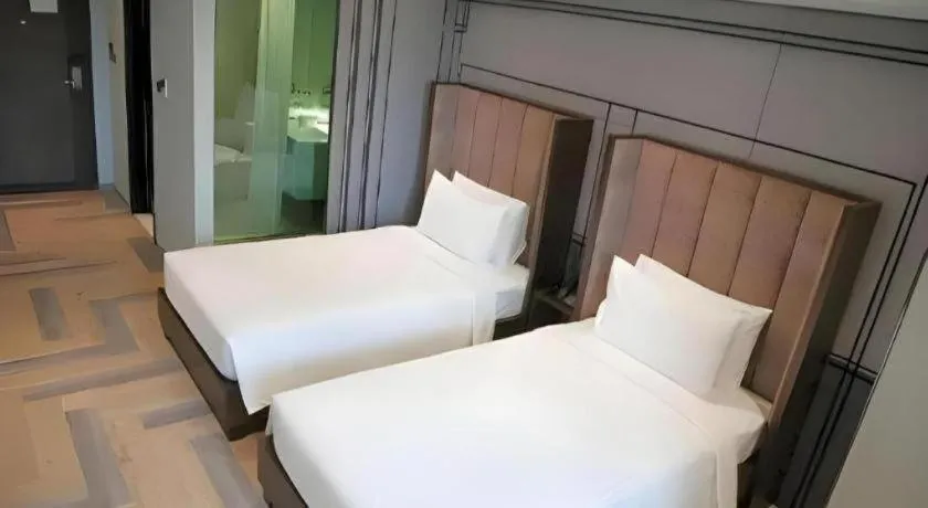 Bed in First Pride Hotel Bangkok