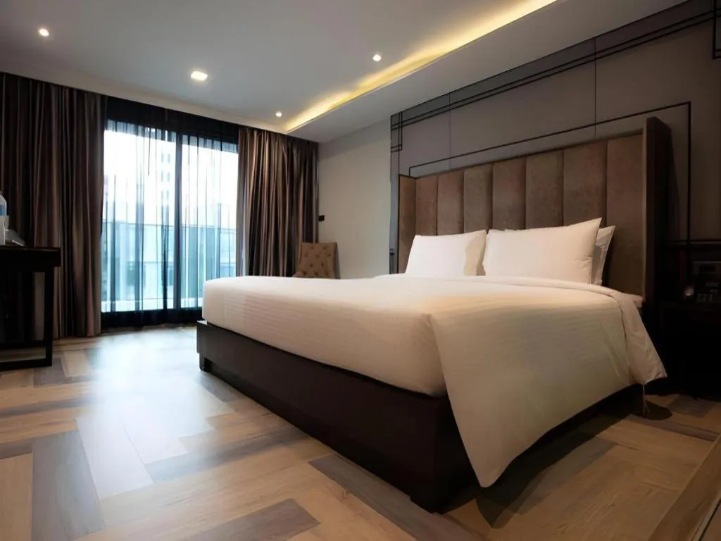 Bed in First Pride Hotel Bangkok