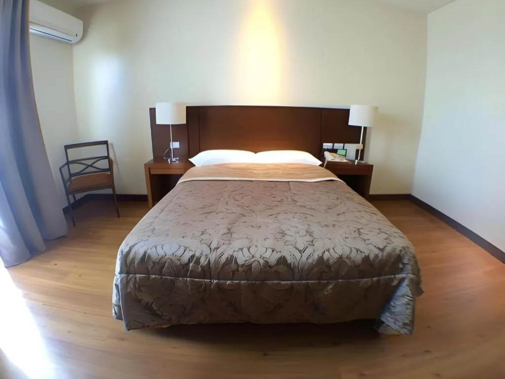 Bed in Mansion Garden Hotel