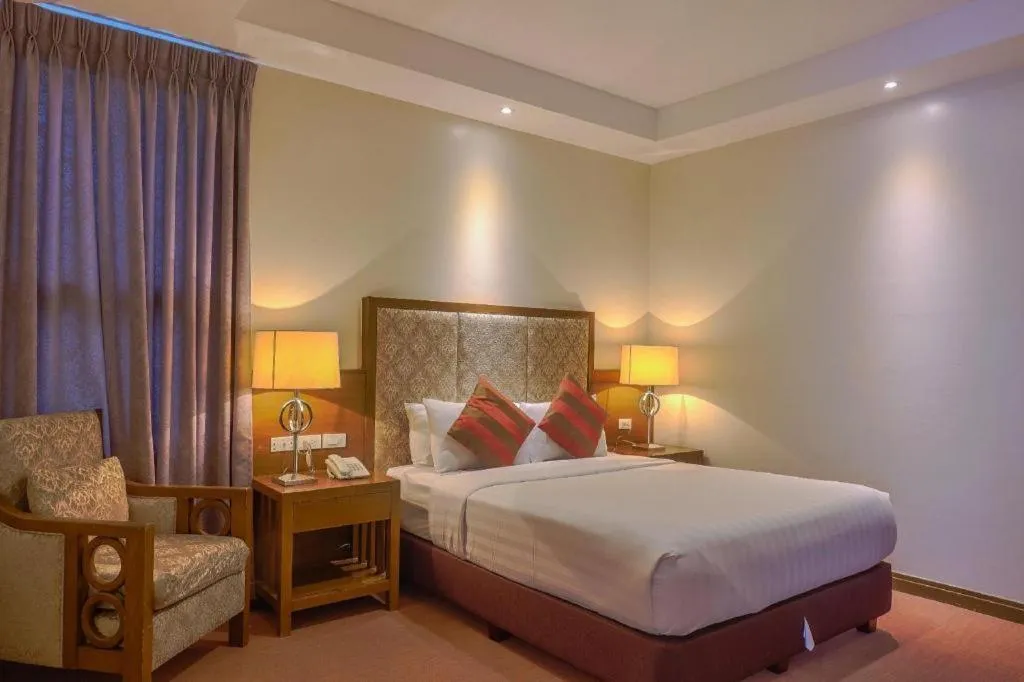 Bed in Mansion Garden Hotel