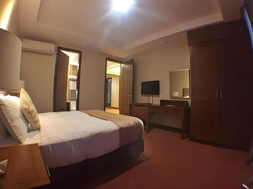 Bed in Mansion Garden Hotel