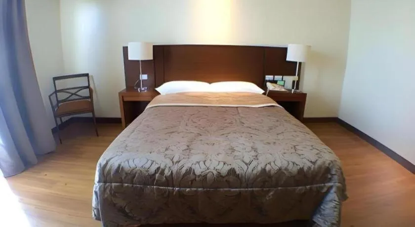 Bed in Mansion Garden Hotel