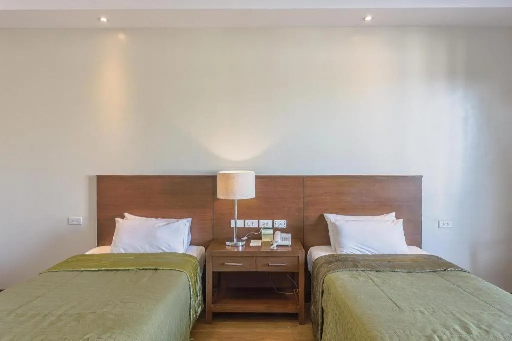 Bed in Mansion Garden Hotel