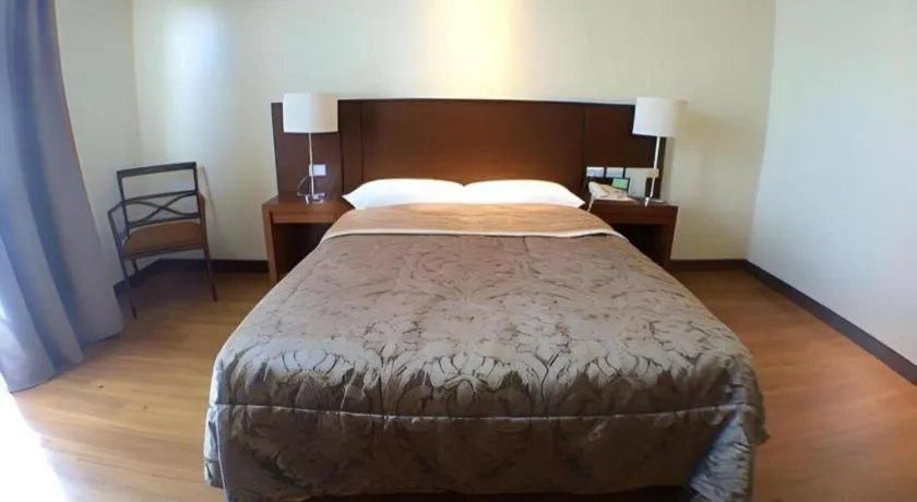 Bed in Mansion Garden Hotel