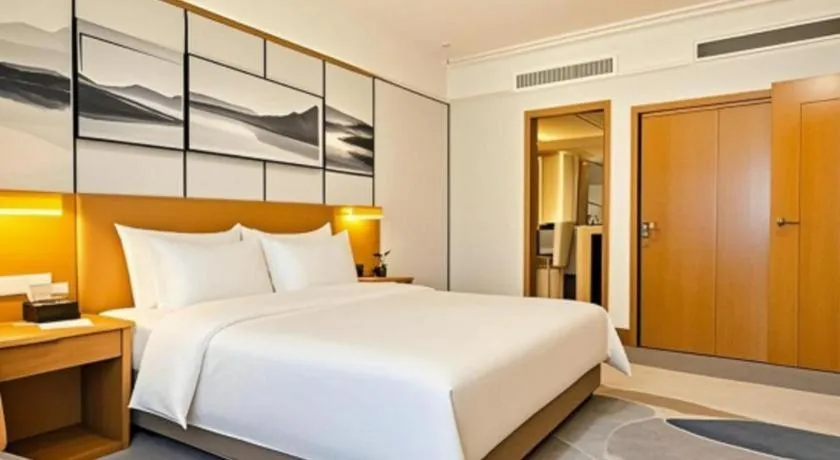 Bed in Xiamen Jingmin Central Hotel