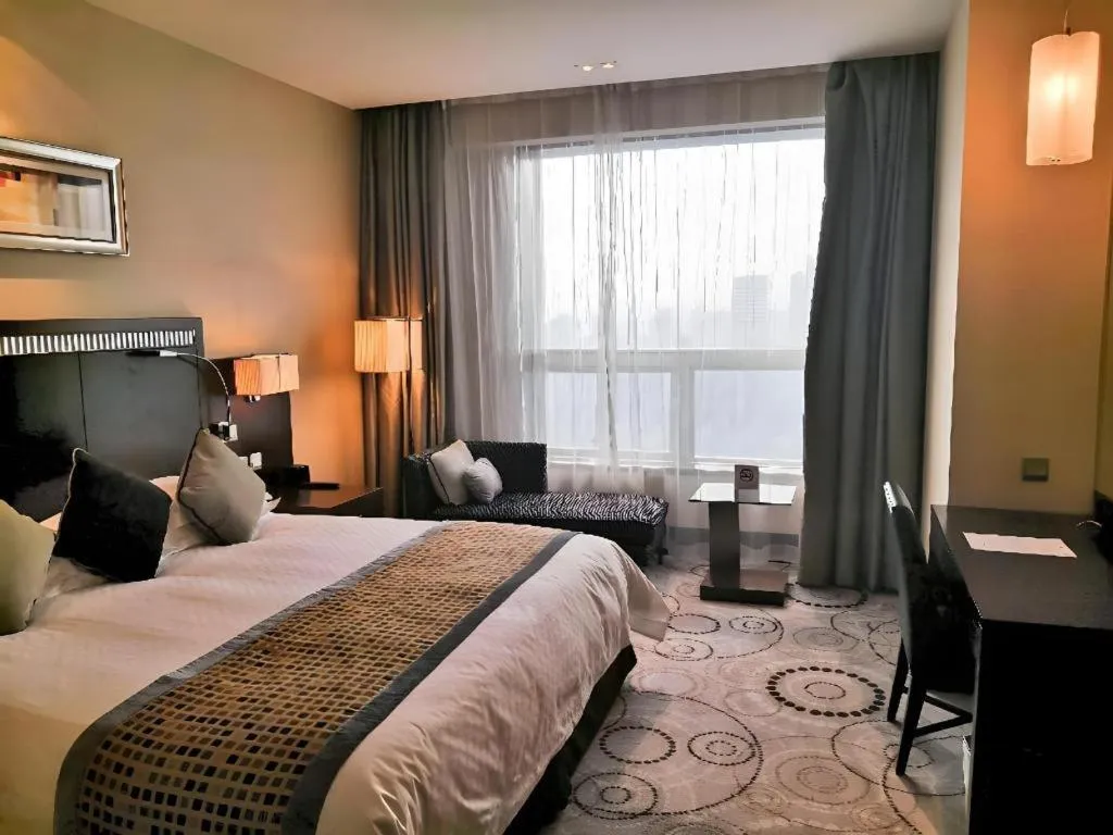 Bed in Grand Soluxe Zhongyou Hotel