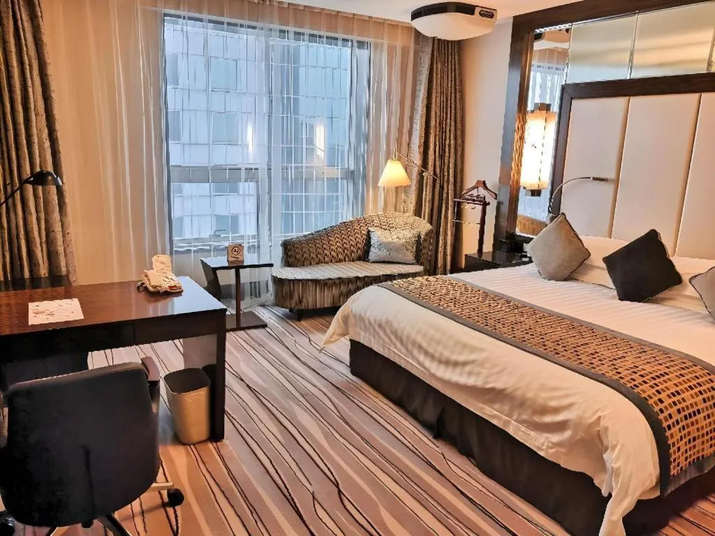 Bed in Grand Soluxe Zhongyou Hotel