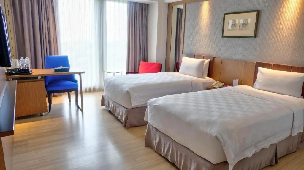 Bed in CLARO Makassar Hotel & Convention