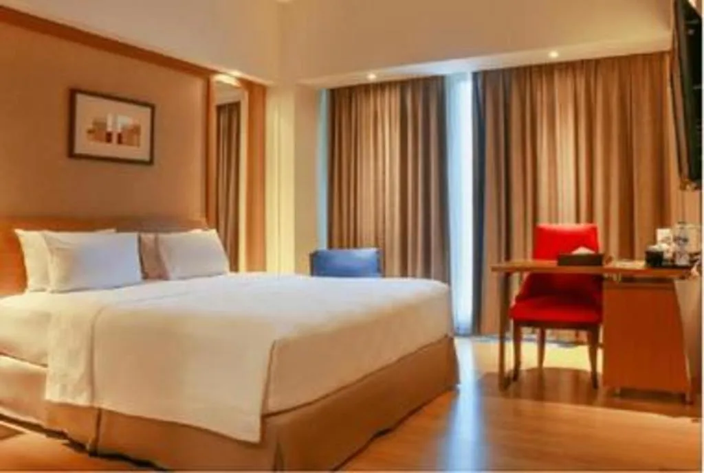 Bed in CLARO Makassar Hotel & Convention