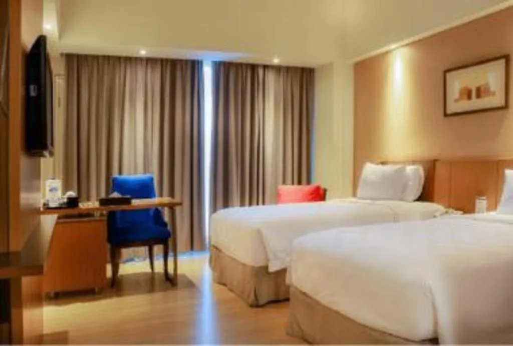 Bed in CLARO Makassar Hotel & Convention