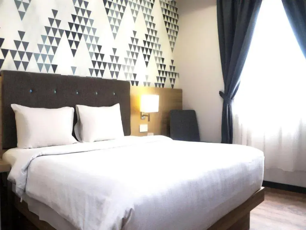 Bed in Orchardz Hotel Gajah Mada Bed in Orchardz Hotel Gajah Mada