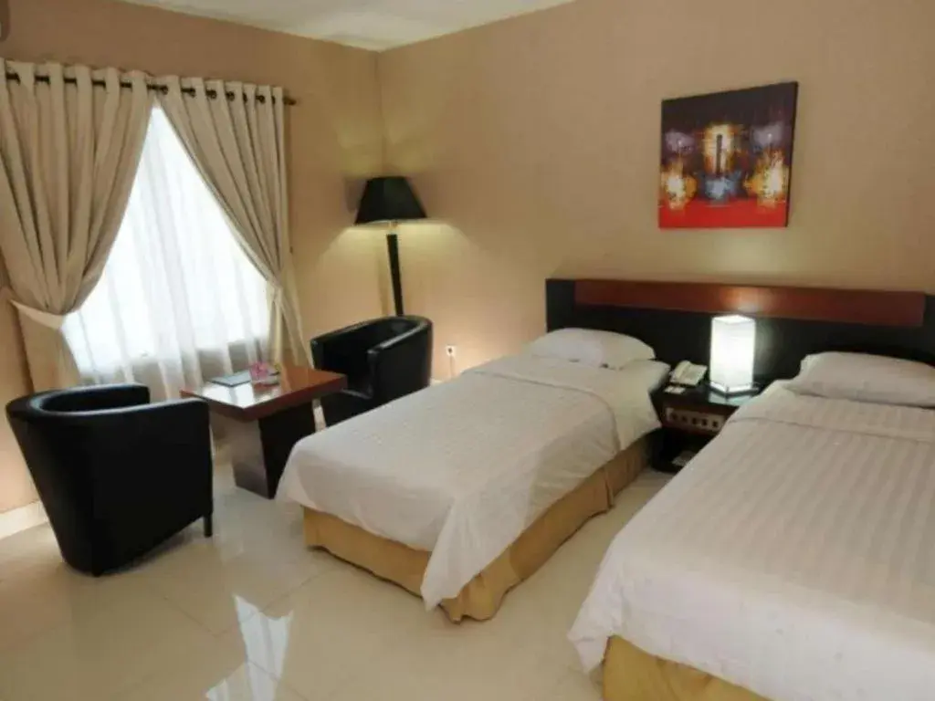 Bed in Orchardz Hotel Gajah Mada Bed in Orchardz Hotel Gajah Mada