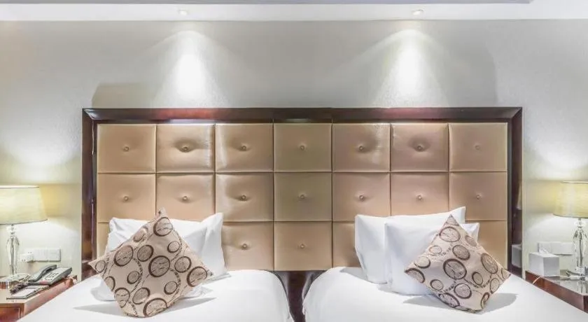 Bed in New Century Grand Hotel Xinxiang