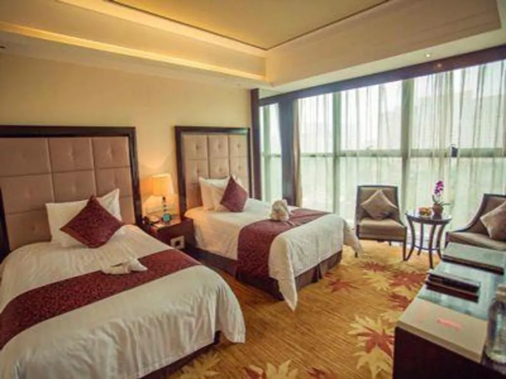 Bed in New Century Grand Hotel Xinxiang