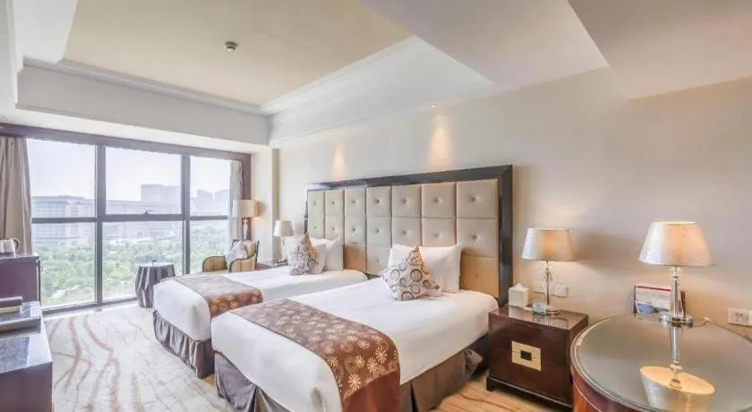 Bed in New Century Grand Hotel Xinxiang