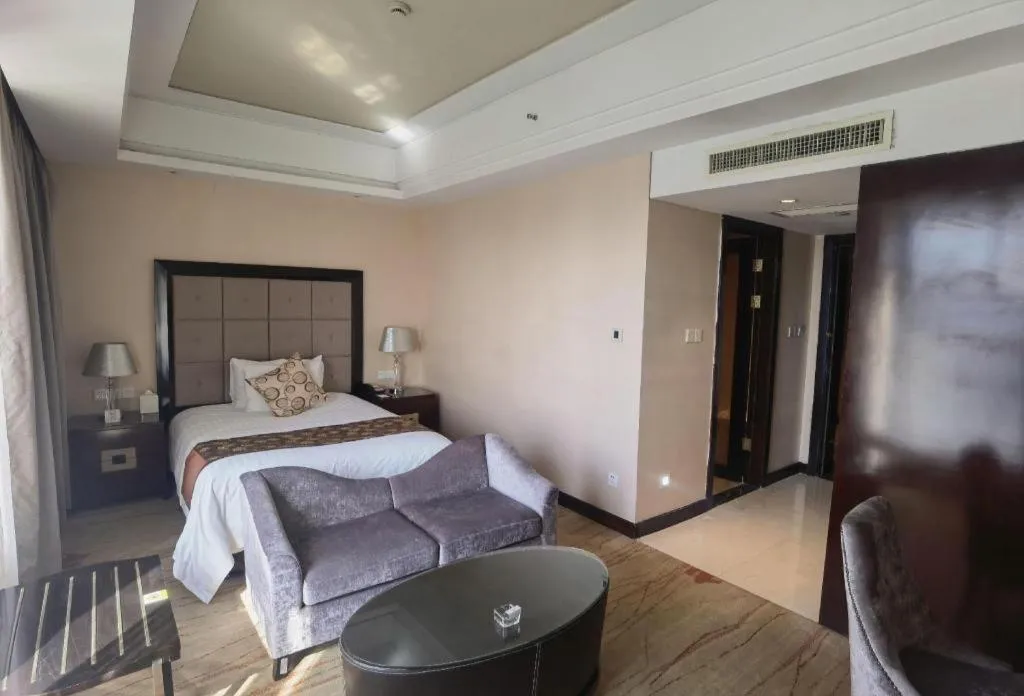 Bed in New Century Grand Hotel Xinxiang