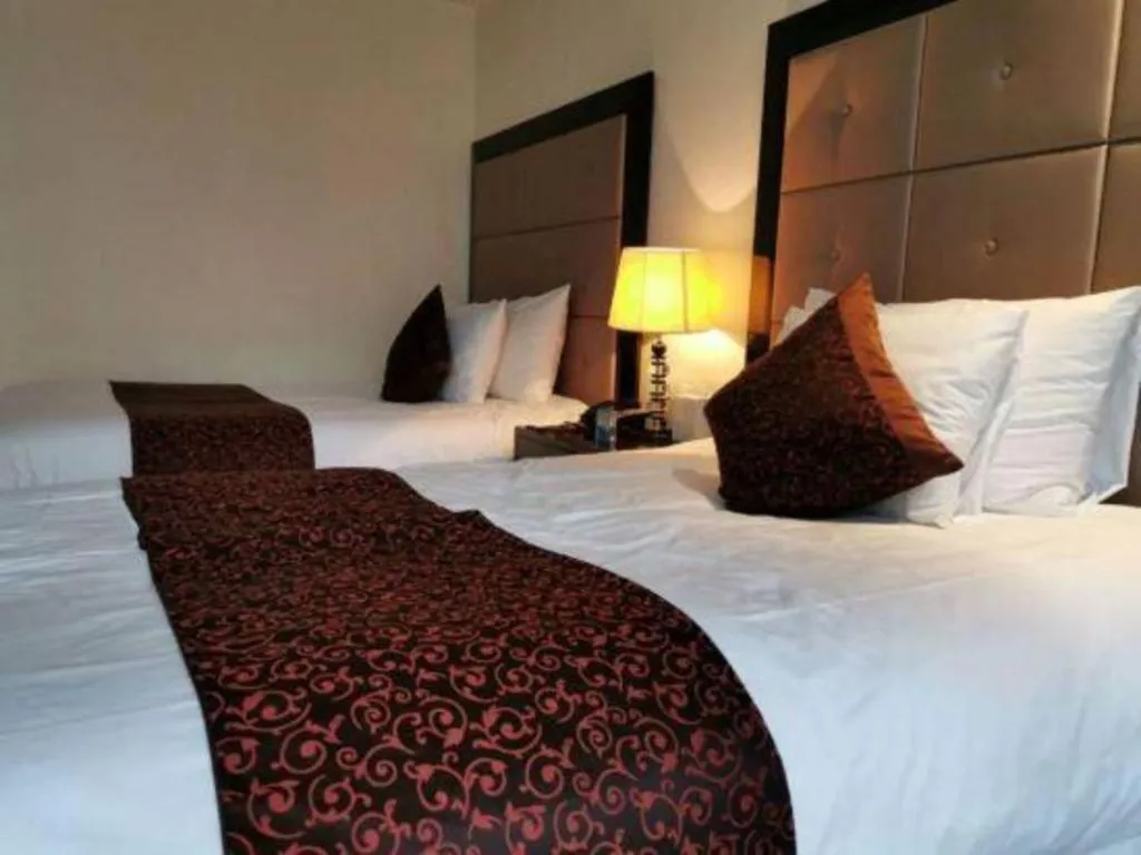 Bed in New Century Grand Hotel Xinxiang