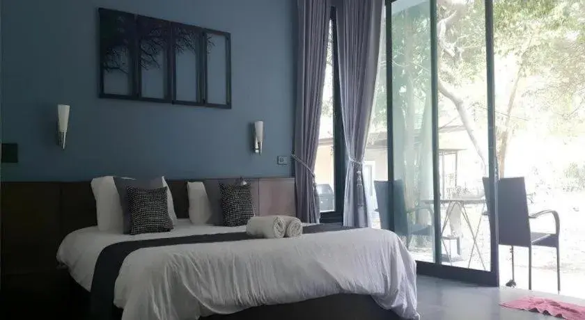 Bed in Baan Chao Mai Beach House Bed in Baan Chao Mai Beach House