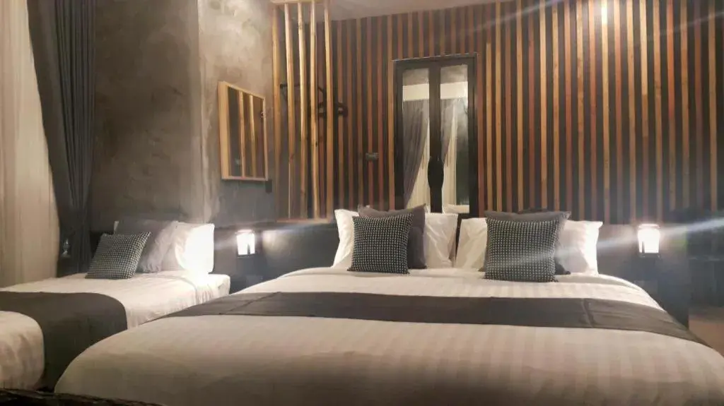 Bed in Baan Chao Mai Beach House Bed in Baan Chao Mai Beach House