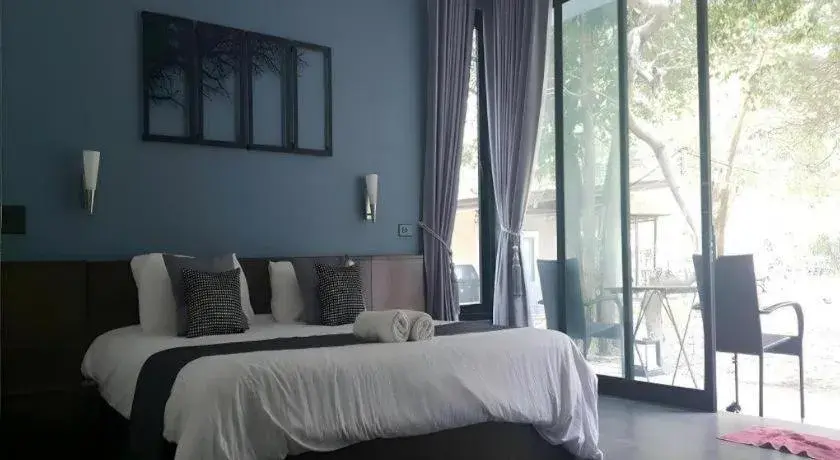 Bed in Baan Chao Mai Beach House Bed in Baan Chao Mai Beach House