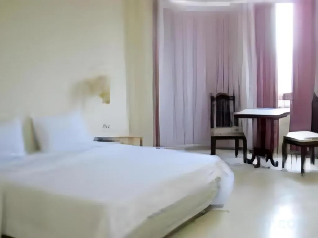 Bed in The Majestic Sakon Nakhon Hotel