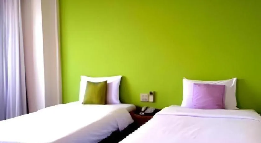 Bed in The Majestic Sakon Nakhon Hotel