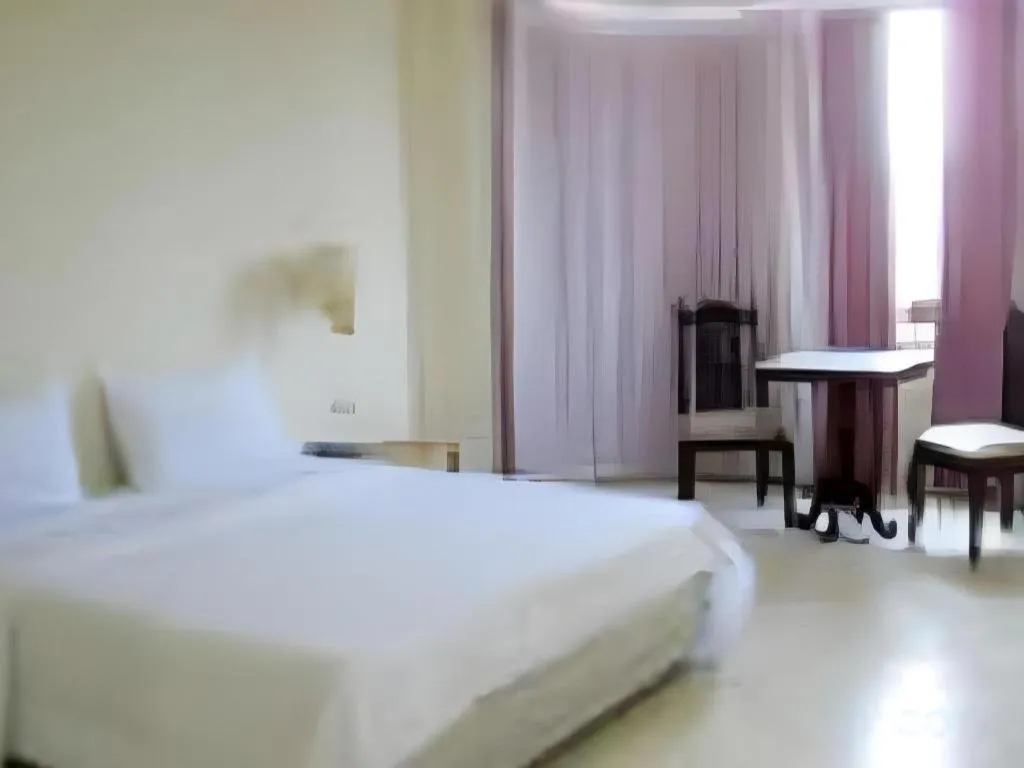 Bed in The Majestic Sakon Nakhon Hotel