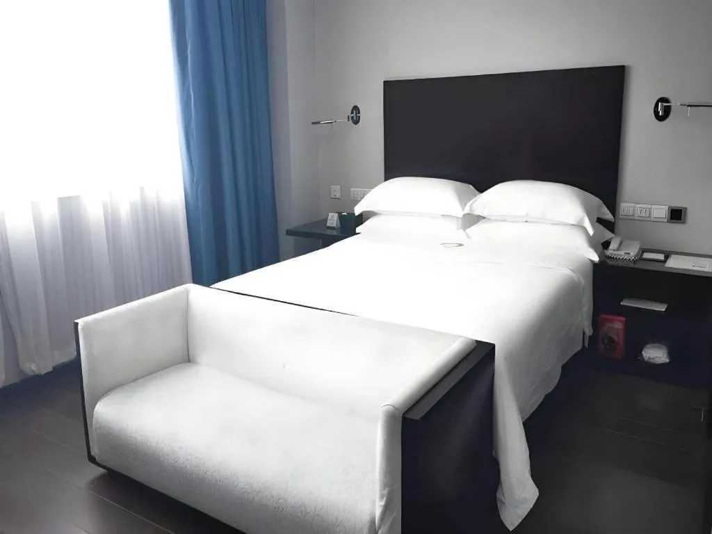 Bed in Guangdong Nanmei Osotto Hotel