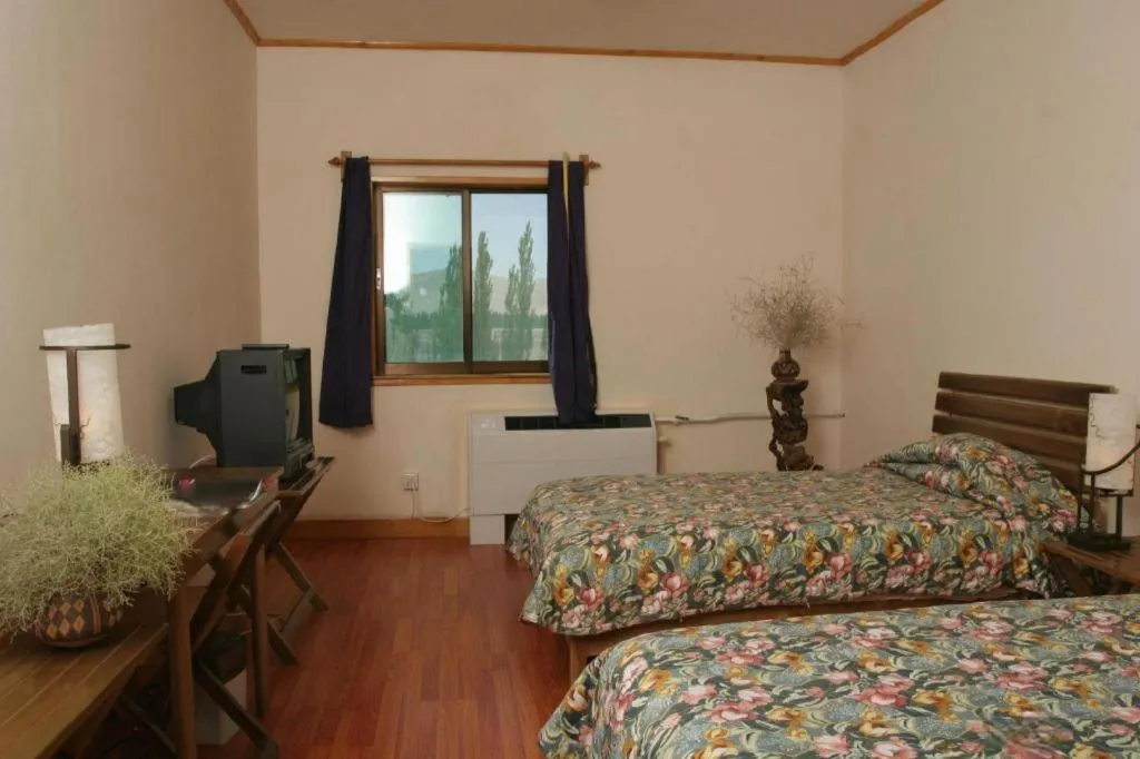 Bed in The Silk Road Dunhuang Hotel