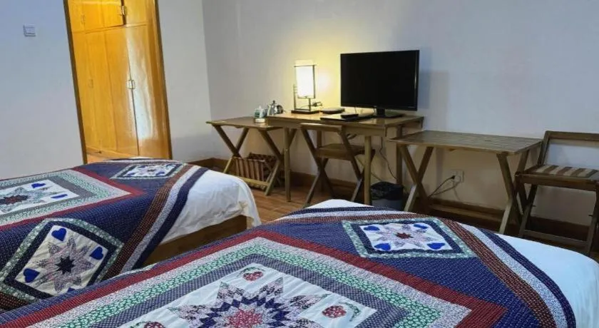 Bed in The Silk Road Dunhuang Hotel